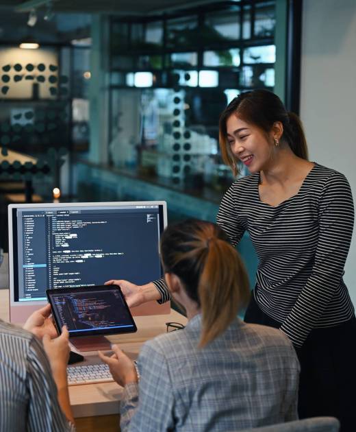 Female project supervisor explaining detail of project developing website design and coding technologies at creative office.